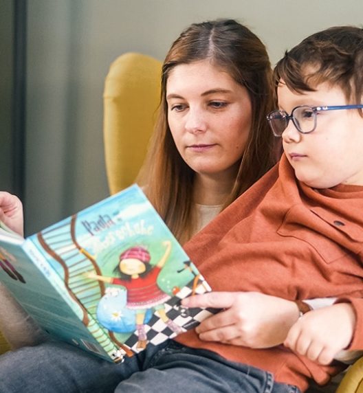 Woman Reading a Book to a Boy — Wearable Technology - Mollii Exopulse
